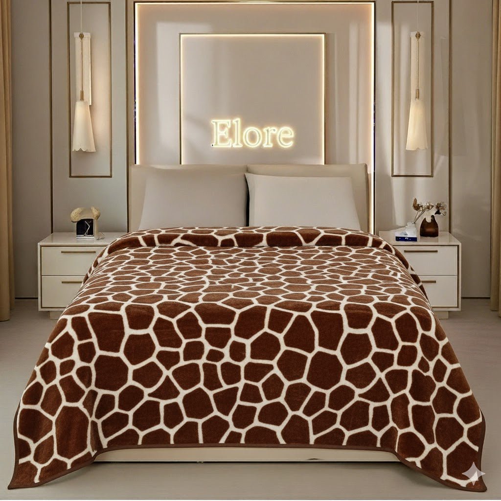 Modern bedroom with giraffe print blanket on bed, illuminated Elore sign on wall, stylish decor