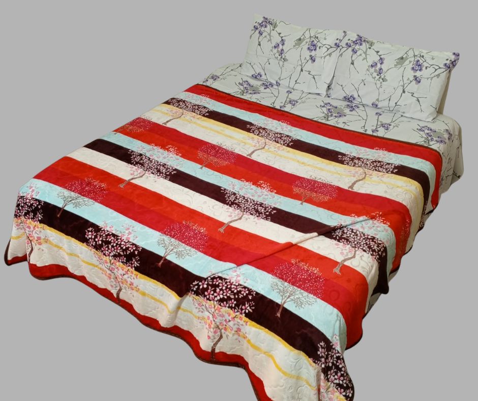 Striped bedspread with tree patterns on a bed with floral pillow covers, isolated background
